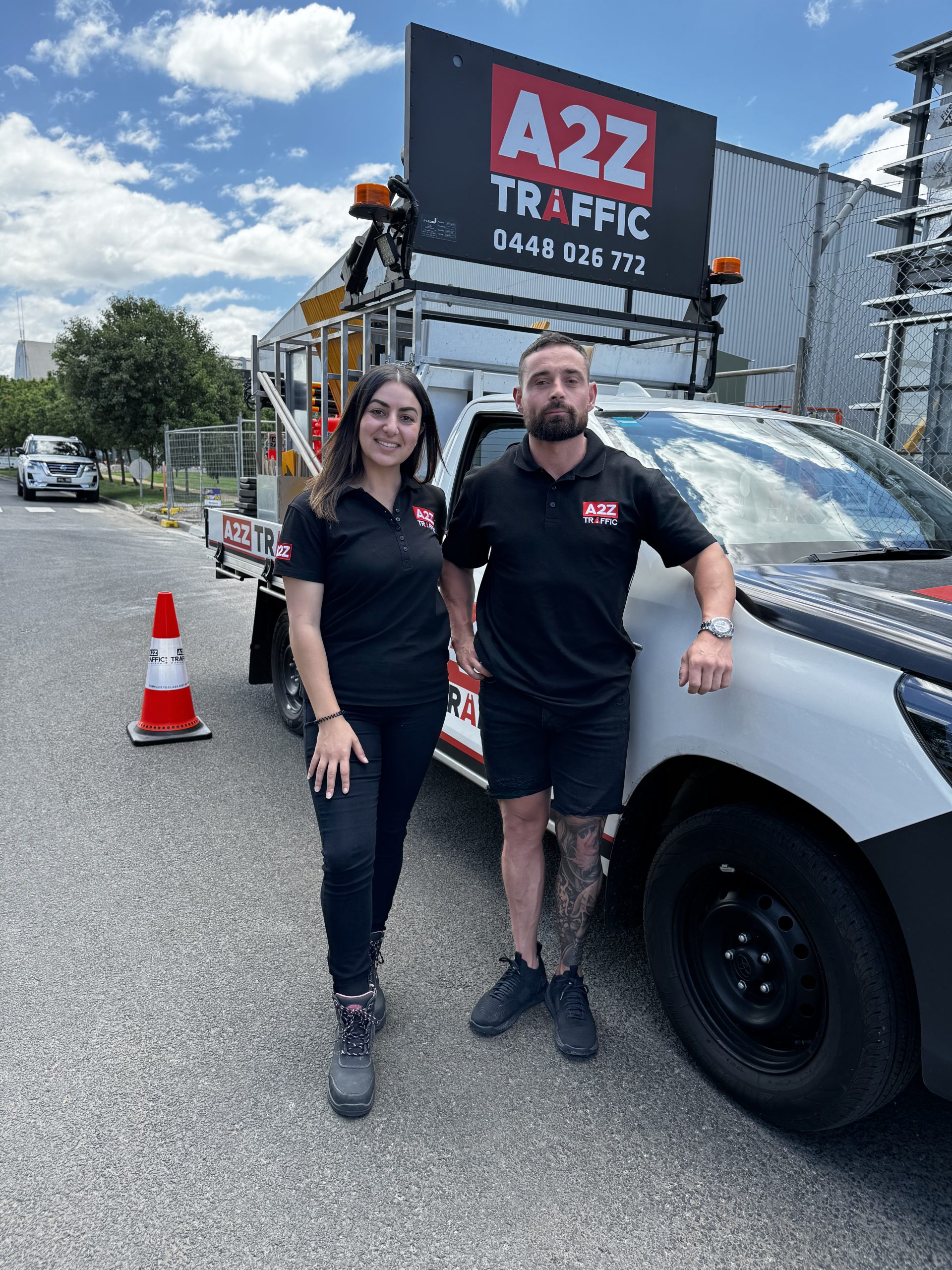 A2Z Traffic team members standing in front of a branded traffic control vehicle in Melbourne, Australia, wearing company uniforms and safety boots, showcasing professional traffic management services.
