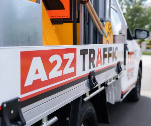 Close-up of an A2Z Traffic vehicle with roadwork signs and equipment in Victoria.